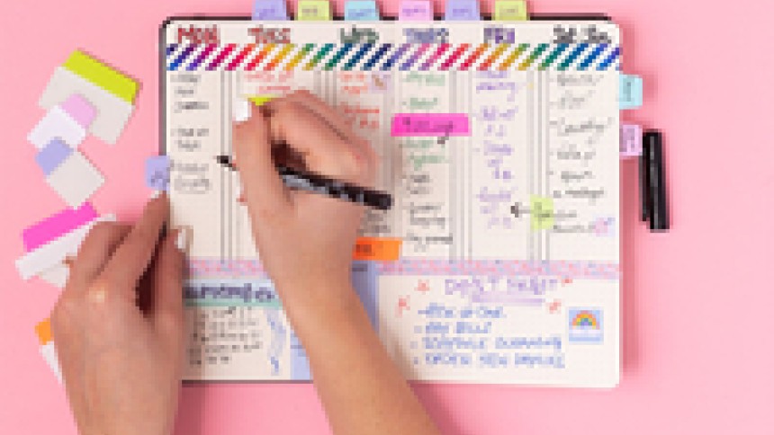 Planner with Avery ultra tabs on pink background