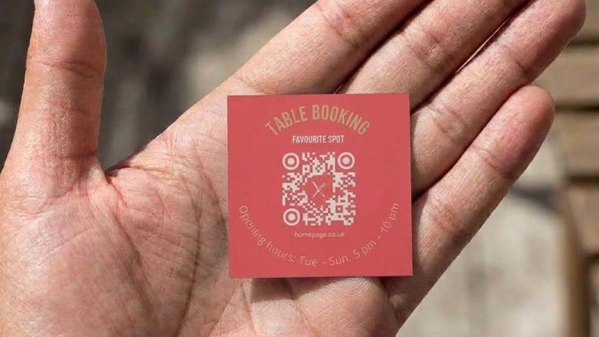 Hand holding a 60mm x 60mm square qr code sticker
