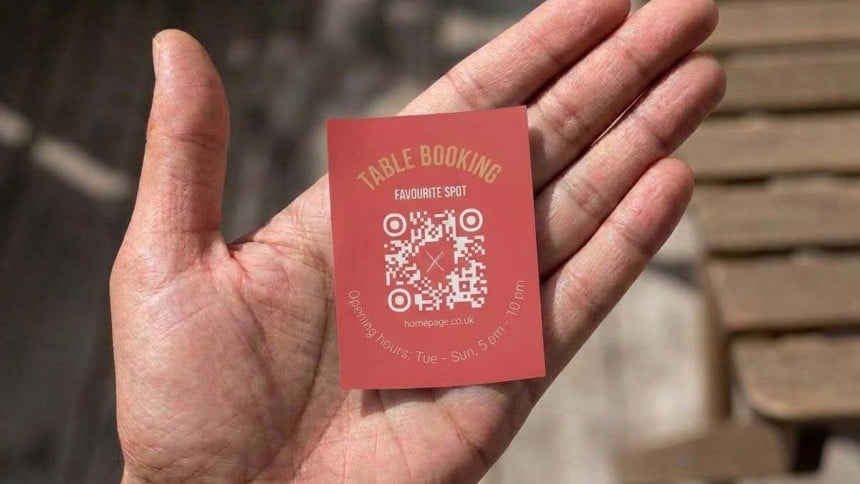 Hand holding a 76 x 51mm qr code sticker