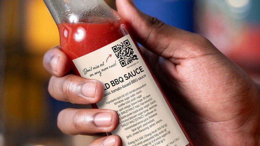 hand holding sauce bottle qr code on label