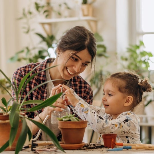 Mother and girl plants green month