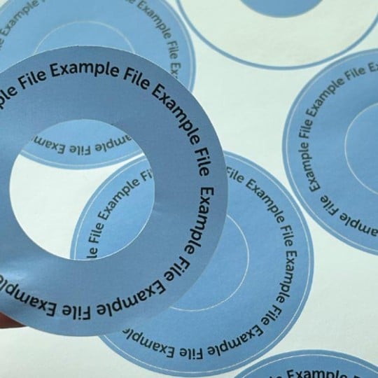 Round label with an inner cutout on a sheet