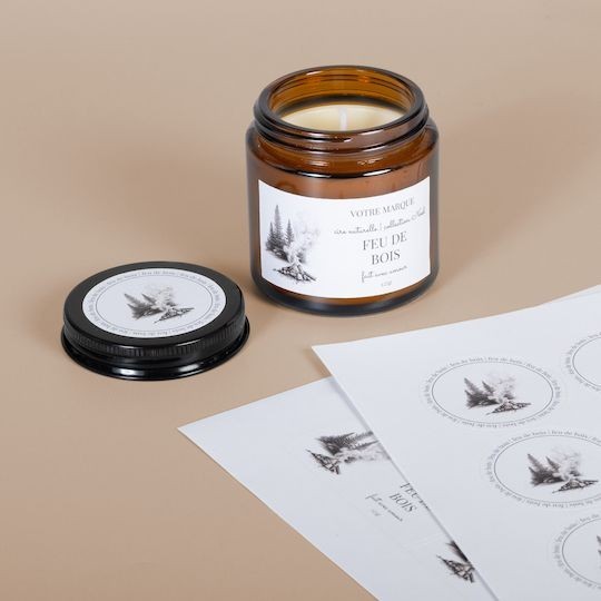 Sticker sheets on desk beside glass jar and lid