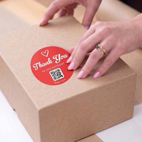 hand applying rate review qr sticker