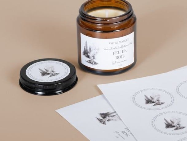 Sticker sheets on desk beside glass jar and lid
