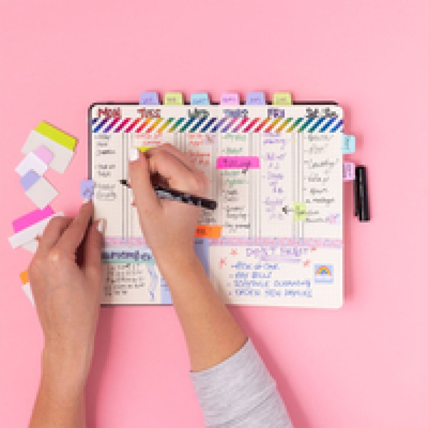 Planner with Avery ultra tabs on pink background