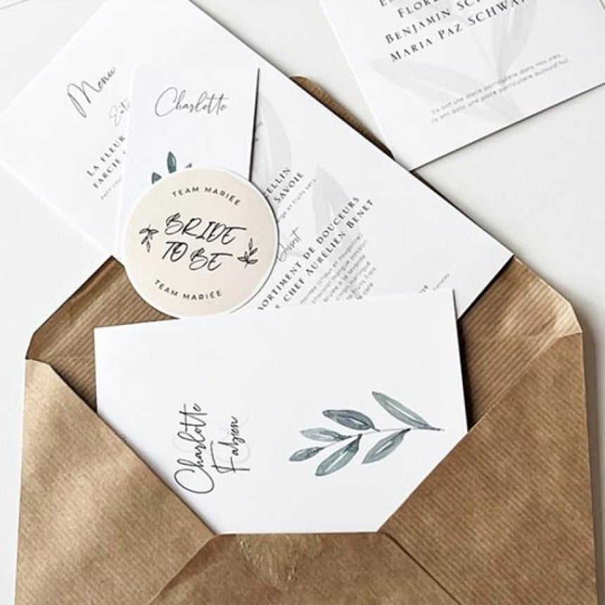 Wedding stationery tumbling out of envelope