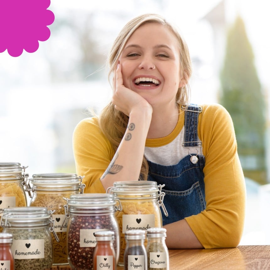 women smiling next to jars filled with food and herbs
