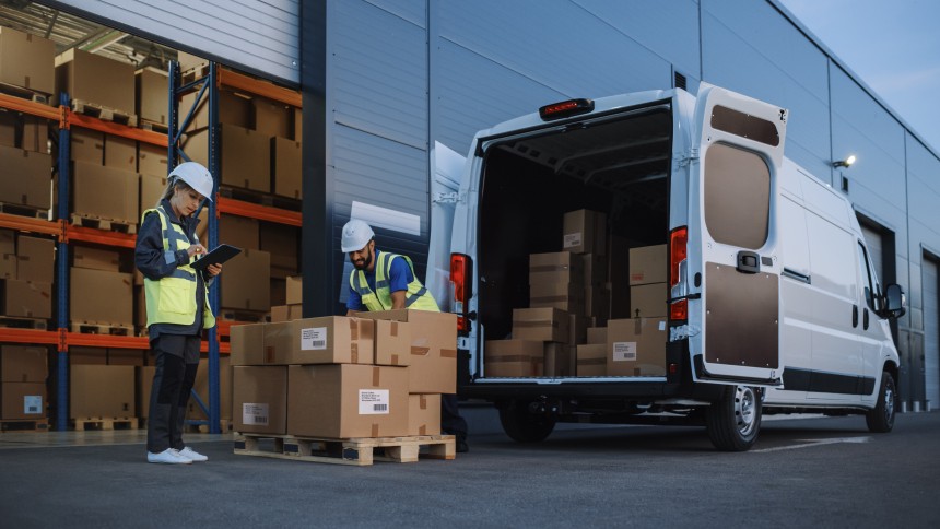 Man packaging boxes into truck
