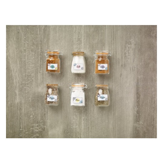 The image features six glass jars filled with various ingredients. They are labeled as Coffee, Salt, Pepper, and Flour. The jars are arranged in two rows on a textured surface.