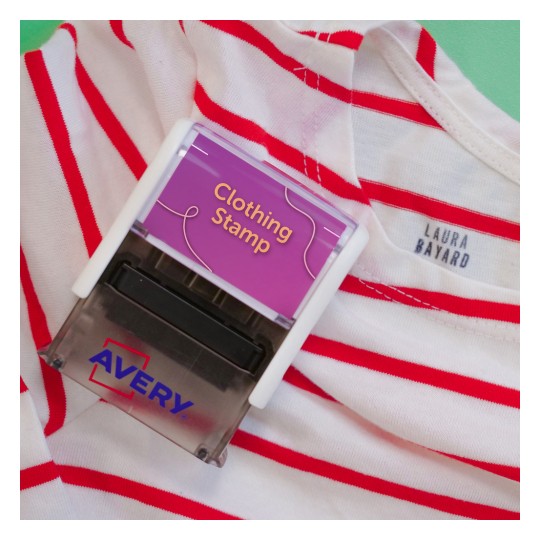The image features a clothing stamp labeled 'Clothing Stamp' on a striped shirt. The shirt has red and white horizontal stripes and displays a tag with the name 'LAURA BAYARD.' The background is a solid color.