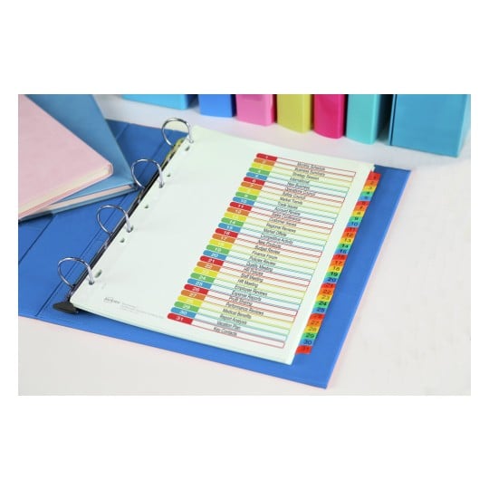 The image shows a binder with a labeled index page. It contains a variety of colorful tabs indicating different sections related to meetings and reports, along with some notebooks in the background.