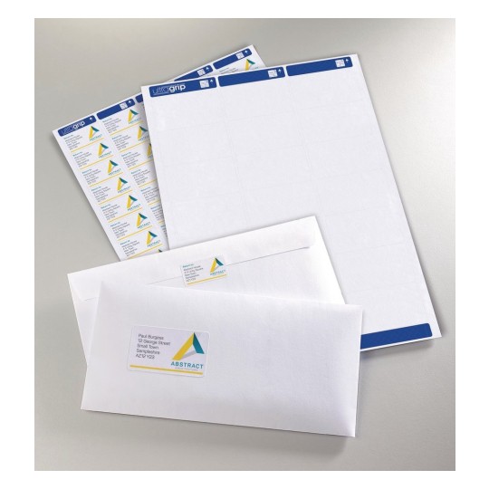 The image shows envelopes and label sheets with a logo and address on them, arranged neatly on a light-colored surface.