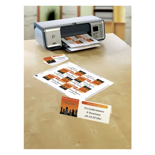 The image shows a printer with reservation cards printed for a restaurant called 'Skyline.' The cards display details like the name M. Lindermann and the reservation for 8 persons starting at 18:00.
