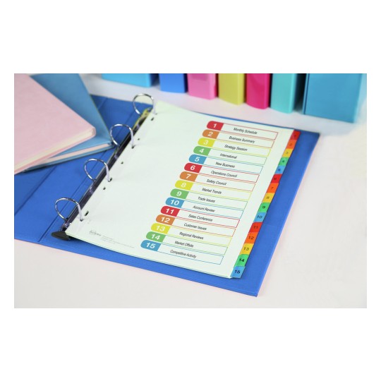 The image shows a close-up of an organized binder with dividers labeled by topics such as 'Monthly Schedule,' 'Business Summary,' and 'Market Trends.' There are also colorful folders and a pink notebook in the background.