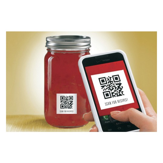 The image features a jar of red sauce with a QR code label, alongside a smartphone scanning the QR code. The label instructs to scan for recipes.