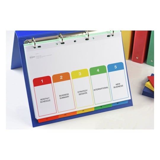 The image shows a binder with a visible sheet containing five colored tabs labeled: Monthly Schedule, Business Summary, Strategy Session, International, and New Business.