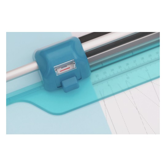 The image features a blue cutting tool, likely a paper cutter or trimmer, positioned over a light blue background. The tool includes a level gauge and a ruler, suggesting it is used for precise cutting or measuring, possibly for crafting or office use.