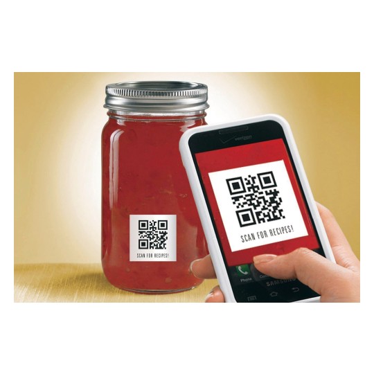 The image shows a jar with a red substance and a QR code label that says 'SCAN FOR RECIPES!' A hand holding a smartphone is positioned near the QR code.