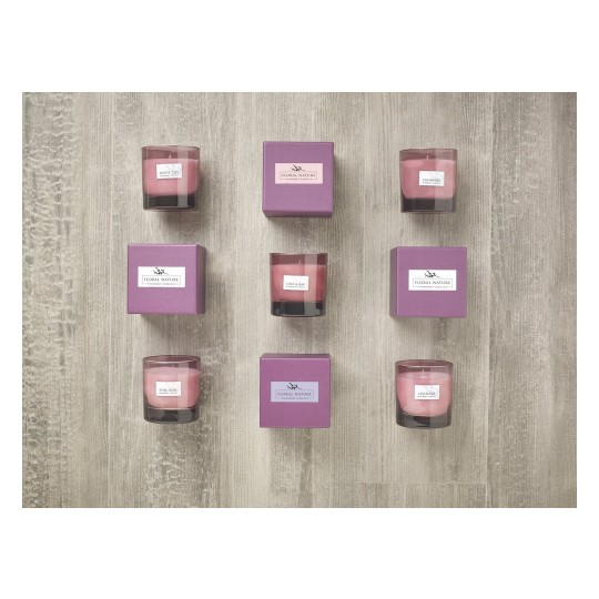 The image features a collection of scented candles arranged in a grid pattern. Each candle is labeled with its fragrance name, such as 'White Lily', 'Cashmere', 'Pink Rose', and 'Lavender'. The candles are paired with matching purple boxes labeled 'Floral Nature'. The background is a light wooden surface.