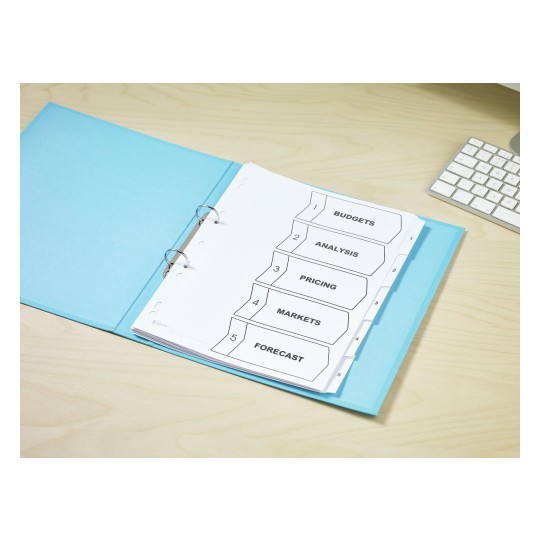 The image shows a binder with labeled tabs for budgets, analysis, pricing, markets, and forecast, placed on a wooden desk next to a keyboard.