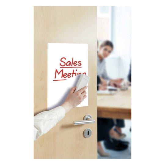 The image features a hand placing a sign that reads 'Sales Meeting' on a door. In the background, people are seen sitting around a table, suggesting a meeting environment.
