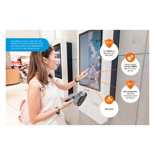 The image shows a woman interacting with a touchscreen kiosk in a public space. The kiosk features information about a product that kills 99.9% of bacteria and microbes and provides 24/7 protection against germs like E.coli and MRSA. The woman is using a payment device and has a pink backpack.