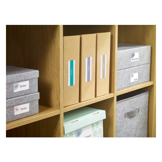 The image shows a wooden shelf with various storage boxes and folders. There are boxes labeled 'Photos', 'Envelopes', and 'Cards', as well as folders for receipts and expenses. The colors are primarily gray, brown, and mint green, creating an organized and tidy appearance.