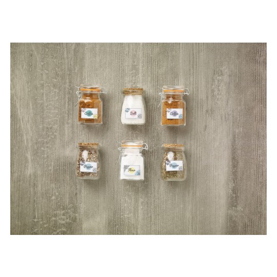 The image features six glass jars filled with various ingredients. They are labeled as Coffee, Salt, Pepper, and Flour. The jars are arranged in two rows on a textured surface.