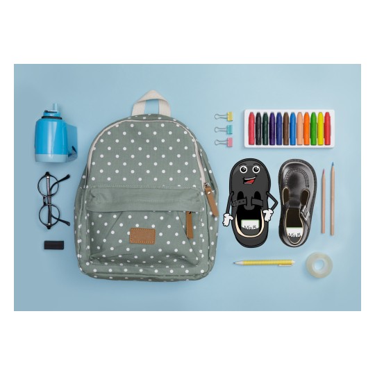 The image shows a green polka dot backpack, a blue pencil sharpener, glasses, an eraser, paperclips, colored pencils, and a figure of a shoe with a smiling face.