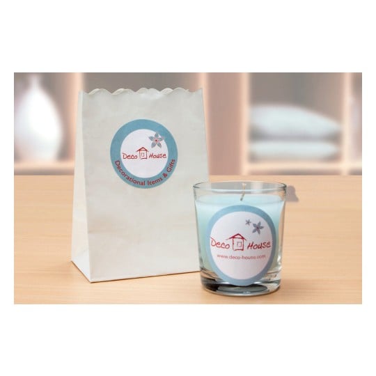 In the image, we see a decorative candle in a glass holder, next to a paper bag with the Deco House logo and the text 'Decorational Items & Gifts'.