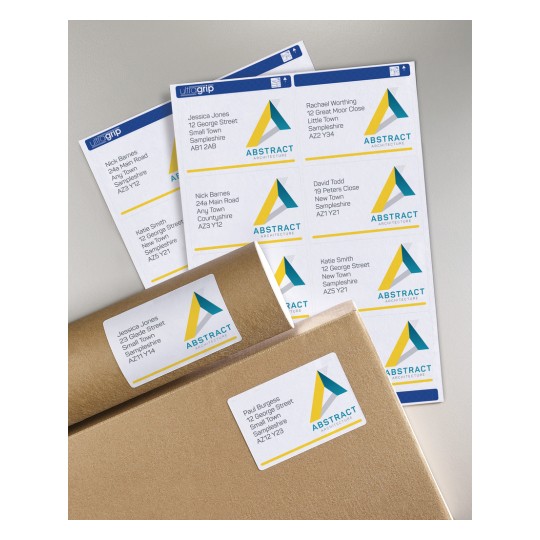 The image shows various address labels with the name and address of individuals, as well as the logo of an architecture firm called 'Abstract Architecture'. The labels are placed on a surface, along with a few envelopes.