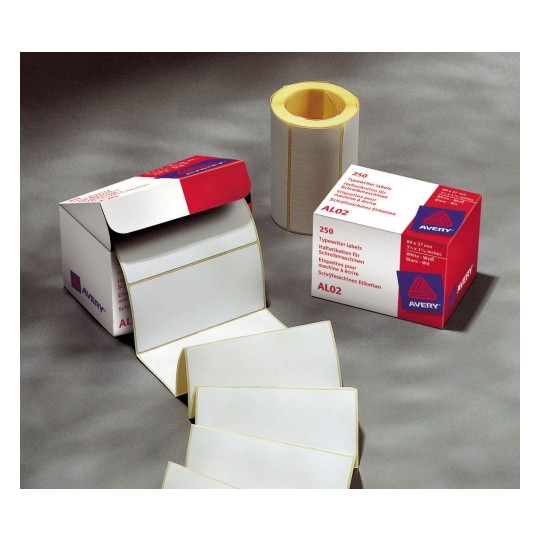 The image shows a box of white typewriter labels from Avery, with a roll of labels beside it. The labels are blank and are stacked. The packaging indicates it contains 250 labels with dimensions 89 x 37 mm.