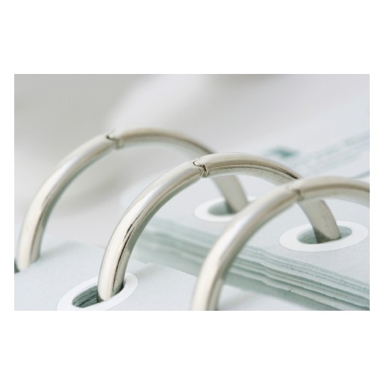 The image shows a close-up of metal rings from a binder holding white sheets of paper together, with a soft focus background.