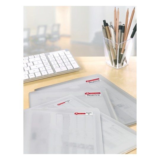 The image shows a desk with a keyboard, a pen holder filled with pens and pencils, and several transparent folders labeled for projects.