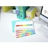 The image shows a neatly organized workspace featuring colorful binders labeled 'WORK', 'PHOTOS', and 'TODO'. A keyboard and a document with labeled sections for 'BUDGETS', 'ANALYSIS', 'PRICING', 'MARKETS', and 'FORECAST' are arranged on a desk along with a container of pens and a plant.