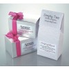 The image features two silver boxes tied with pink ribbons, labeled as 'Luxury handmade truffles' from 'le nouveau chocolatier.' There is also a white bag of tea labeled 'Simply Tea' with descriptions indicating it is 100% organic loose-leaf tea, and another label saying 'Original Blend.'