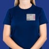 The image shows a person wearing a navy blue t-shirt with a name tag attached. The name tag displays 'Cloe Hopper' and the word 'Marketing,' along with a 'VOID' label. The background is solid blue.