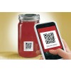 The image features a jar of red sauce with a QR code label, alongside a smartphone scanning the QR code. The label instructs to scan for recipes.