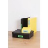 The image displays a collection of organized storage boxes and binders on a wooden surface. There are three items: a large black box labeled 'FORMS', a medium black binder labeled 'INVOICES', and a small yellow binder labeled 'REGULATION', along with a small yellow box labeled 'RECEIPTS'. These items suggest office organization and document management.