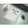The image features a clear binder with a brochure labeled 'Holiday Homes' on top, accompanied by a stapler and a computer mouse on a desk.