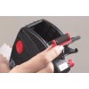 The image shows a hand holding a small roller mechanism, possibly for a tape dispenser or labeling tool. The device appears black with red buttons and is partially opened, showcasing its internal components.