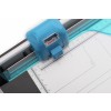 The image shows a close-up of a blue paper trimmer with a ruler along the side. It depicts the cutting mechanism and measurement markings on the cutting surface.