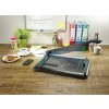 The image shows an office workspace with a paper cutter, a cup of coffee, cookies on a plate, a smartphone, colorful pens, and a potted plant, with notes and file organizers in the background.