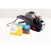 The image features a black labeling gun alongside two boxes of tablets. One box contains Aspirin 300mg tablets and the other contains relief tablets with Sodium Alginate. The products are displayed on a neutral background.