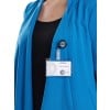The image shows a person wearing a blue blazer with a name badge visible. The badge indicates 'VISITEUR' and appears to contain a name and possibly an organization logo.