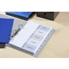 The image shows a binder with tabbed sections labeled 'Agenda', 'Budget', 'Details', 'Clients', and 'Services', alongside some blue folders and a black box on a wooden surface.