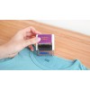 A person is using an Avery clothing stamp on a blue shirt. The stamp clearly reads 'Clothing Stamp'.