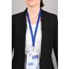 The image shows a person wearing a black blazer, standing against a grey background. They are displaying a name badge with blue lanyard. The badge includes the name 'Michèle SAMPLIN' and is associated with an industry group meeting.