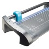 The image shows a cutting tool, specifically a guillotine paper cutter, featuring a clear cutting line guide and measurement grid on the surface.